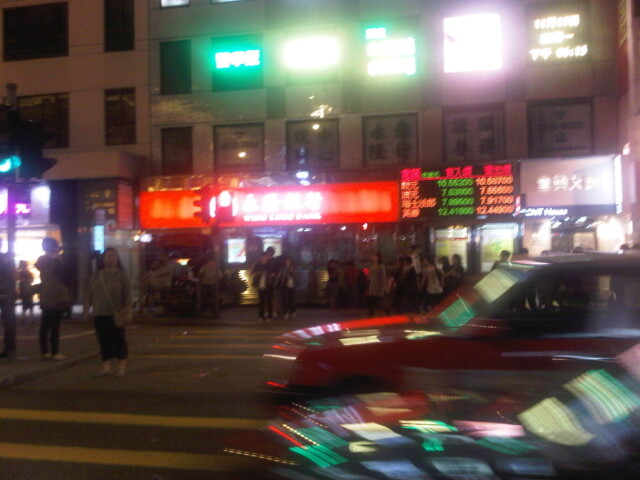 Waiting to cross the street to get to the tram